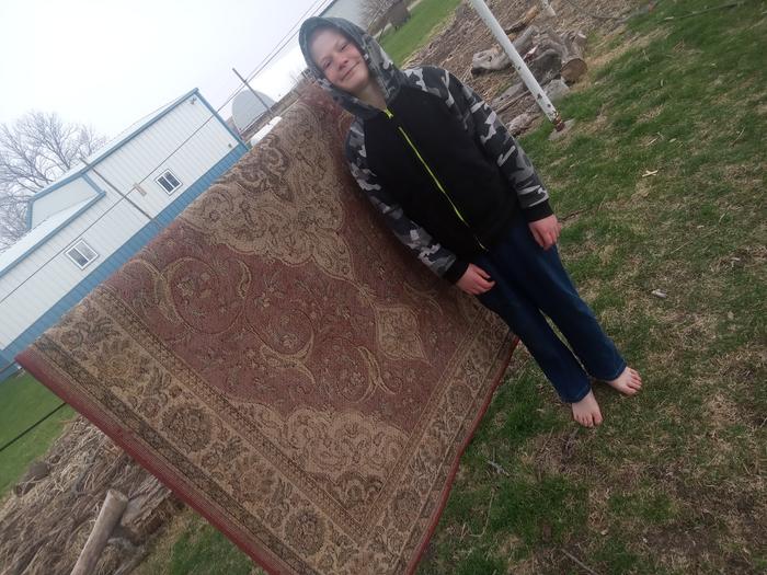 Needed help getting in the rug as it started to rain. It was out all afternoon and we flipped it halfway.