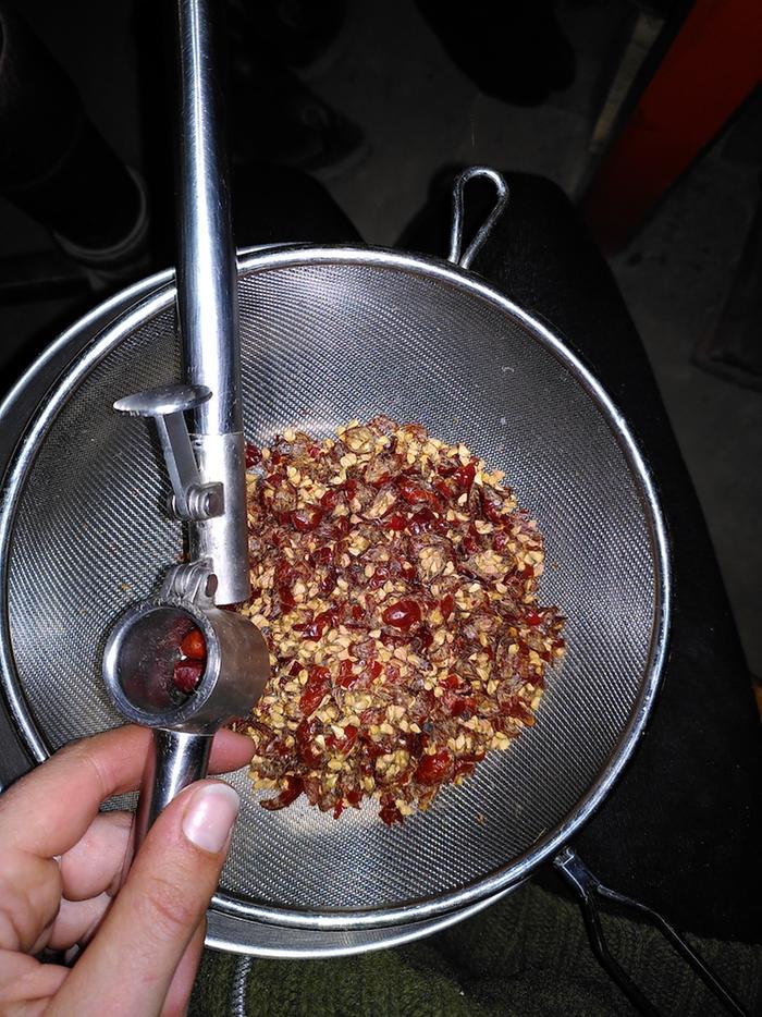 Crushing the dried rosehips.