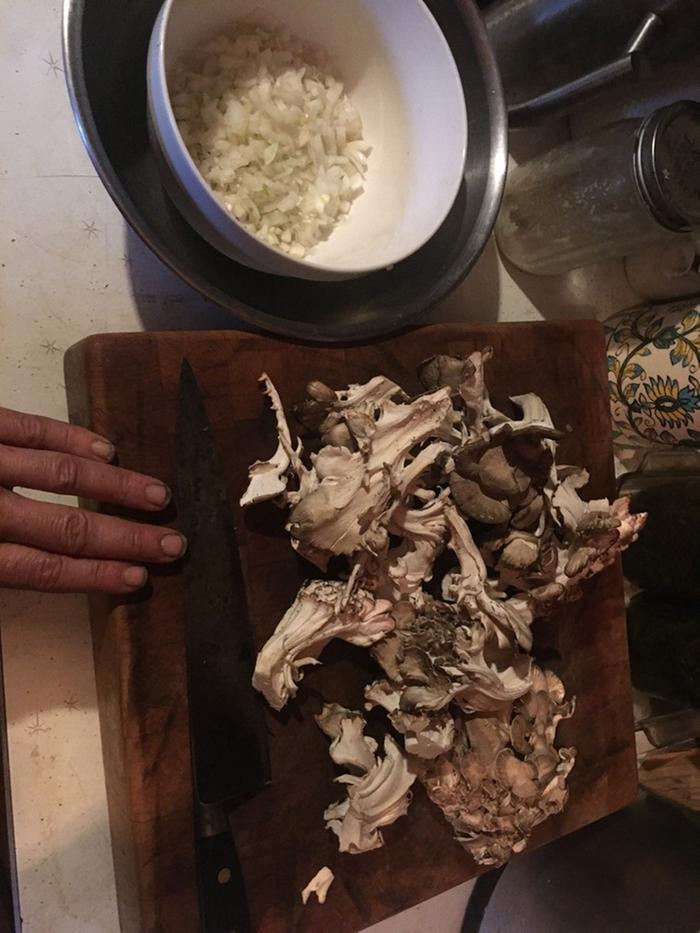 onions and hen of the woods being chopped