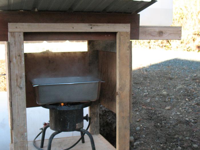 Sap boiling setup outdoors.