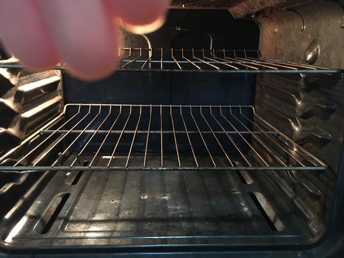 Dirty oven ( my hand is there because the oven light was leaving a glare)