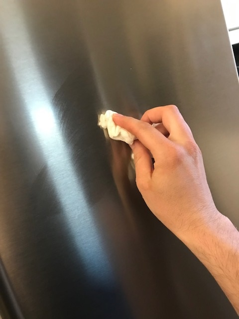 Polishing the front of the fridge