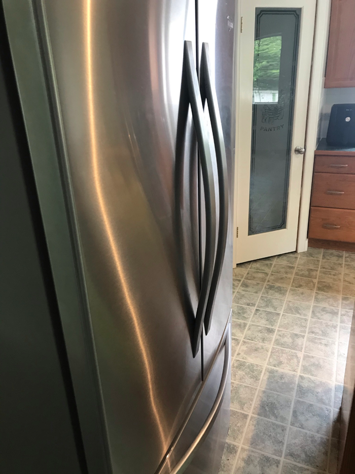 The clean and shiny front of the fridge