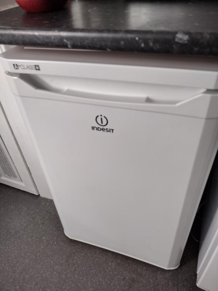 The clean fridge pushed back into place