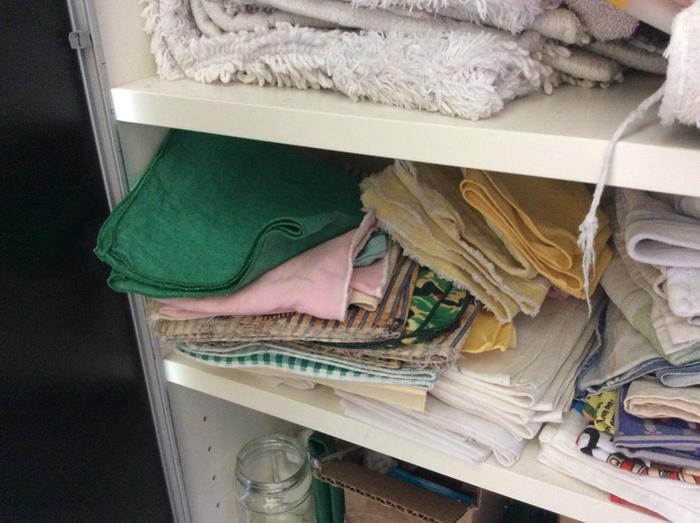 Napkins in a cupboard right by the dining table, ready for use.