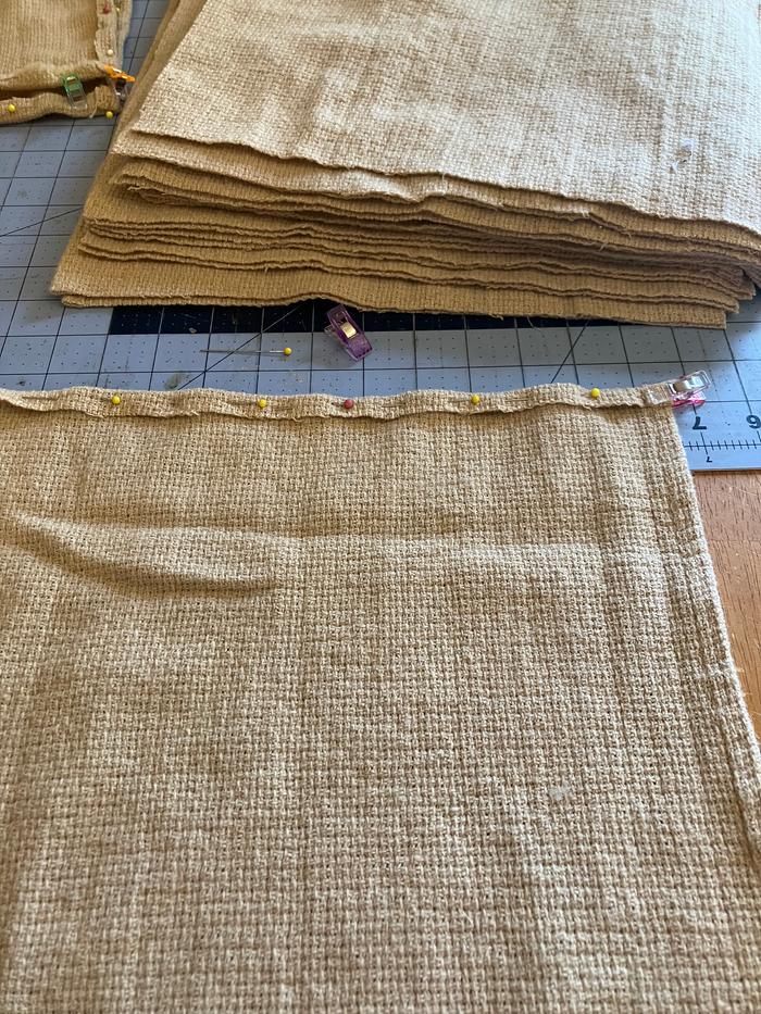 Using pins and clips, I folded the raw edges over to prepare for sewing.
