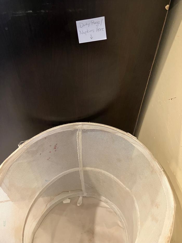 A small laundry in the corner of the kitchen for easy access to put the dirty ones in.