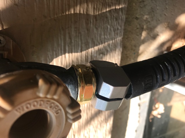 The new hose end in place being tested. If you look closely, there is a small drip coming out of the faucet knob and/or the upper vacuum breaker. But the hose doesn't leak.