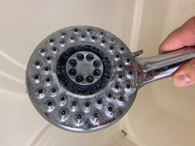 White buildup in shower sprayers