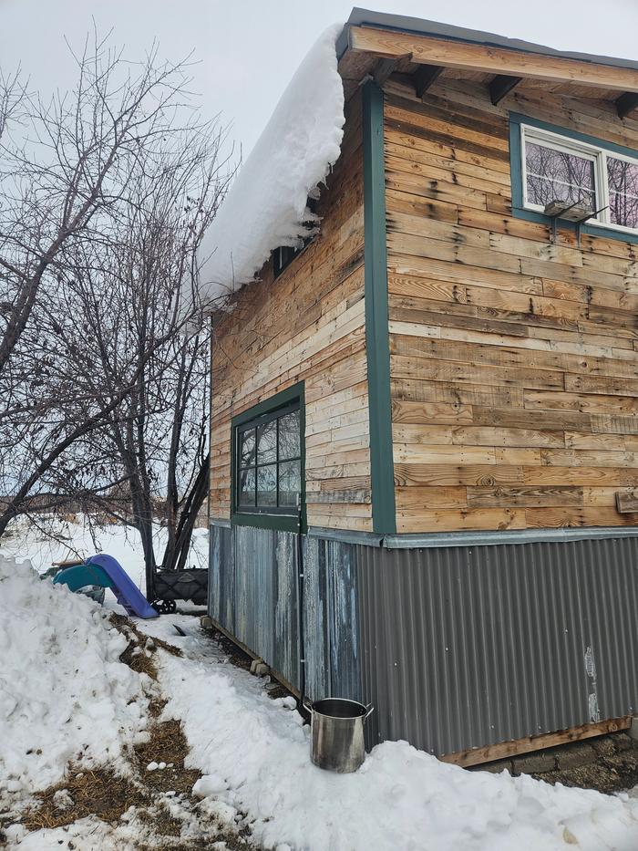 The pot is under the event, on the corner of the building