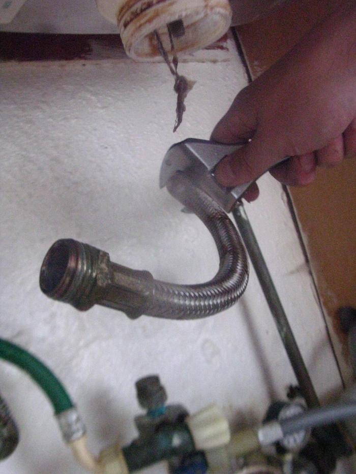 Having removed braided connector from old faucet (actually from copper piping connector) and u-bend from sink.