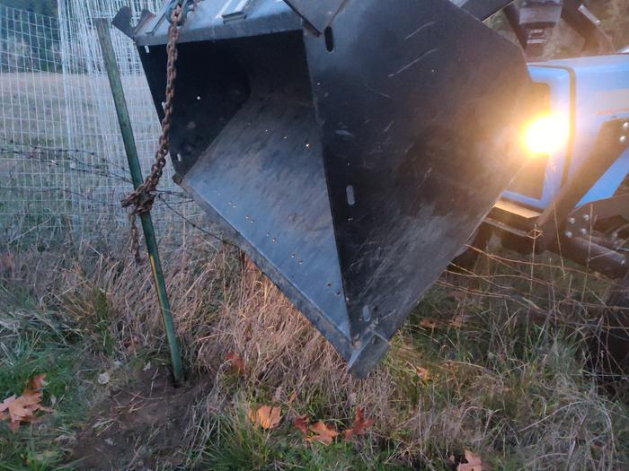 action shot of taking down the fence using tractor to pull t-posts that were set excessively deep