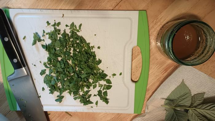 fill the jar 1/4 to 1/3 with honey, add a splash of vodka and stir to incorporate. Let sit while you chop some of the herbs, removed from stems.