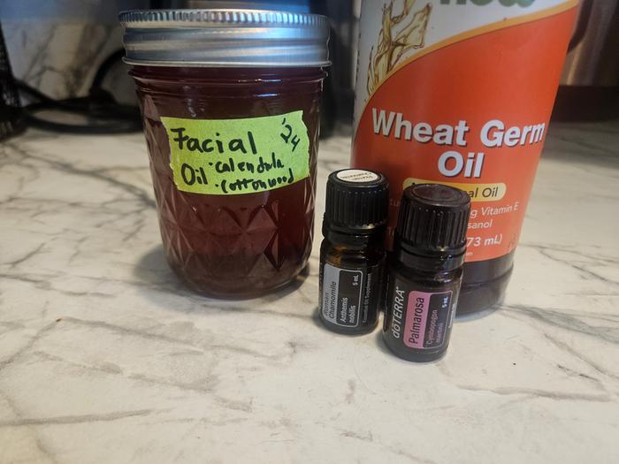 At the end of heating and straining I added wheat germ (vit e) oil and chamomile and palmarosa oils, which feel amazing on my face. Here is the finished, labeled jar of calendula-infused-face oil. It's my preferred moisturizer