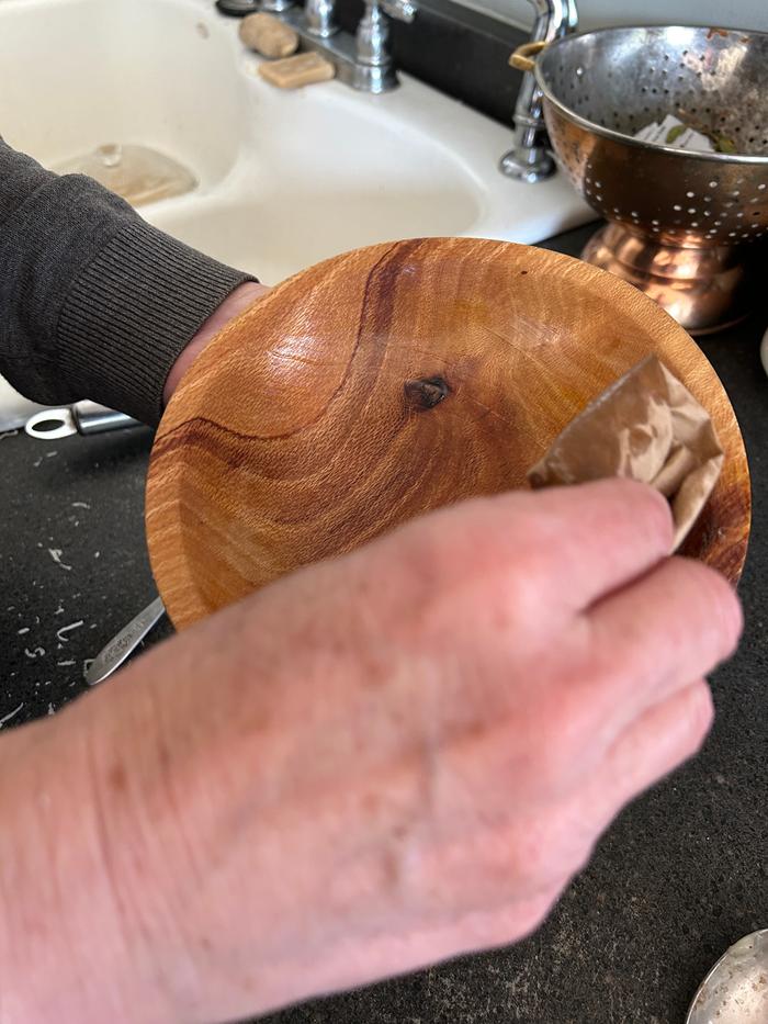 Removing grease with a piece of paper to use later as a fire starter 