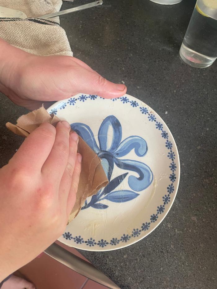 Here I am wiping old the plate with brown paper. To be used later as a fire starter