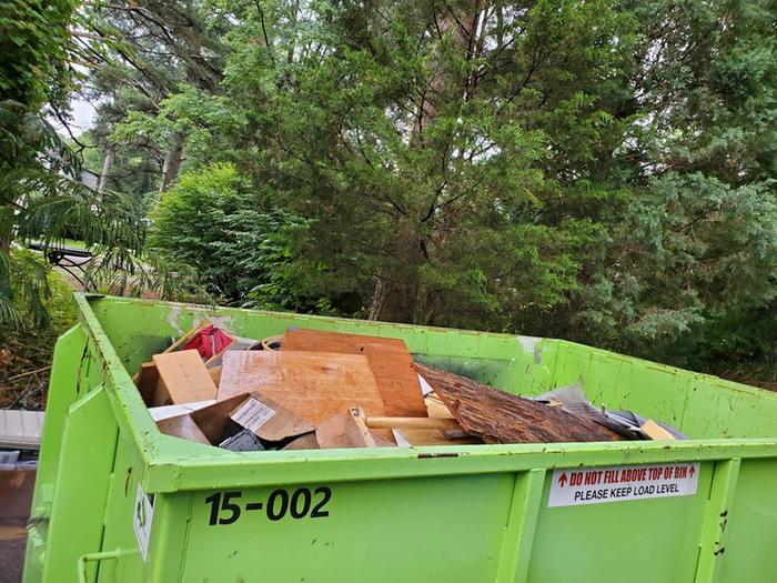 I filled it to the brim with 15 cubic yards of rotted particle board, the junk you saw earlier (most of it rotted with rusty nails), and also stuff from my basement.