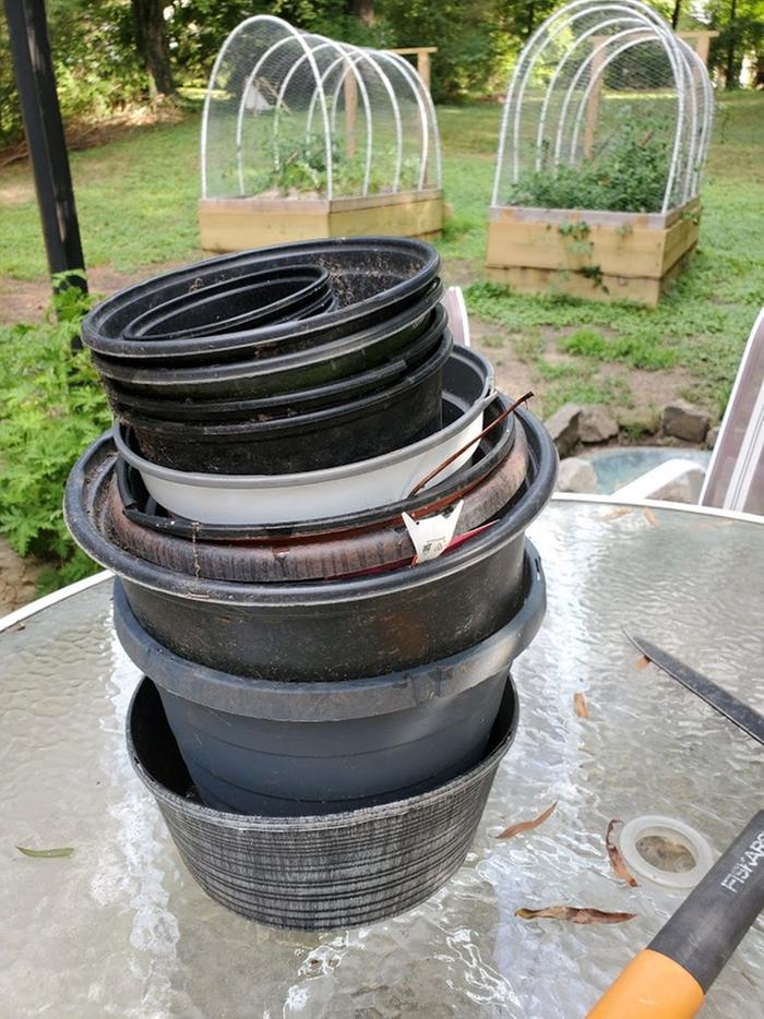 A collection I recovered was this stack of planters from various plant purchases and reuse efforts over the years. They. Were. Everywhere.