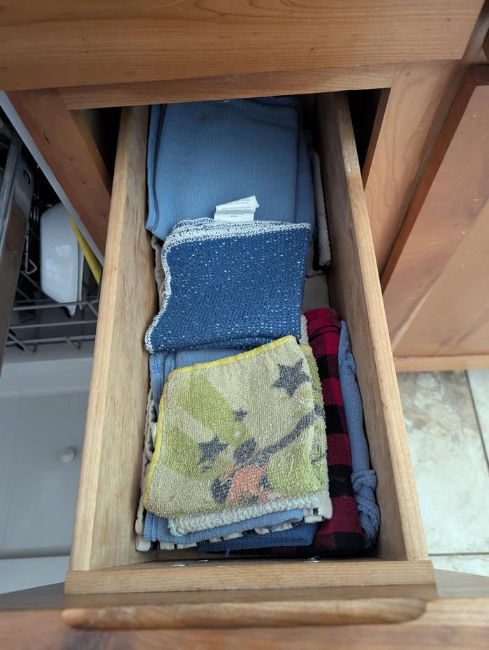 I keep some rags in a kitchen drawer and my unpaper towels in the “Clean” basket.