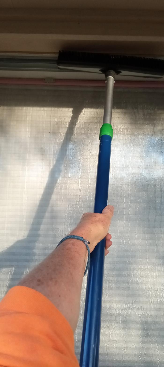 me cleaning window with squeegee