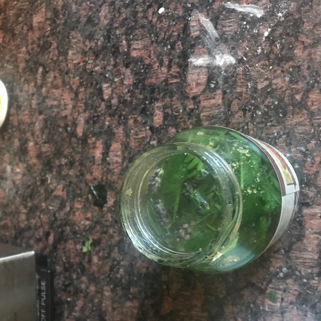 Steeping. You can see some of the lavender blossoms floating on the mint. This is the used honey jar.