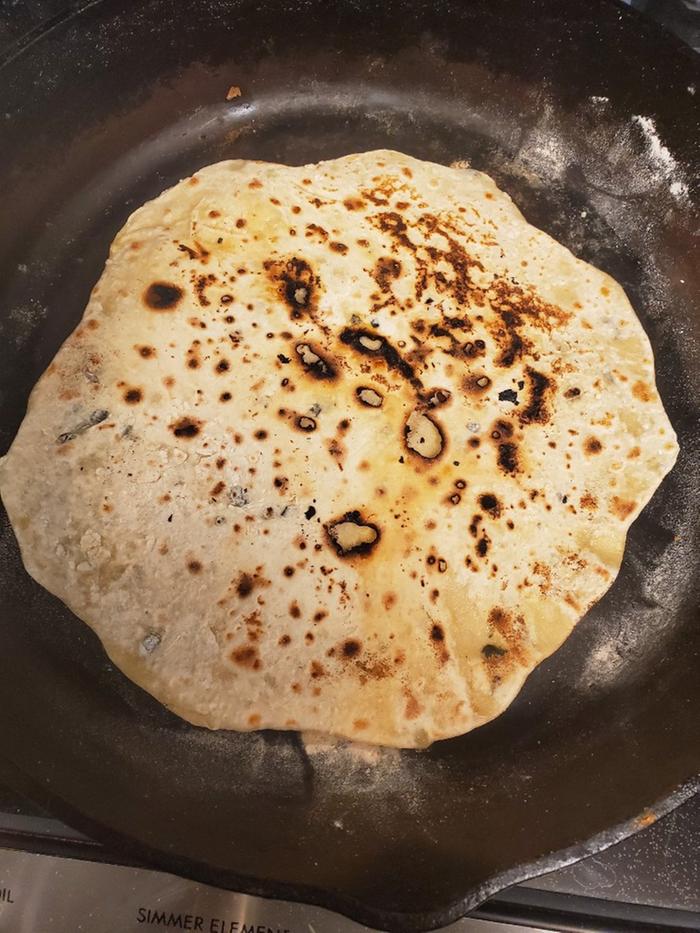 zucchini tortilla frying in cast iron skillet