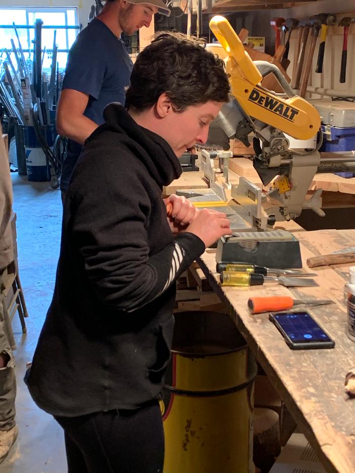 Ashley sharpening a chisel in the shop