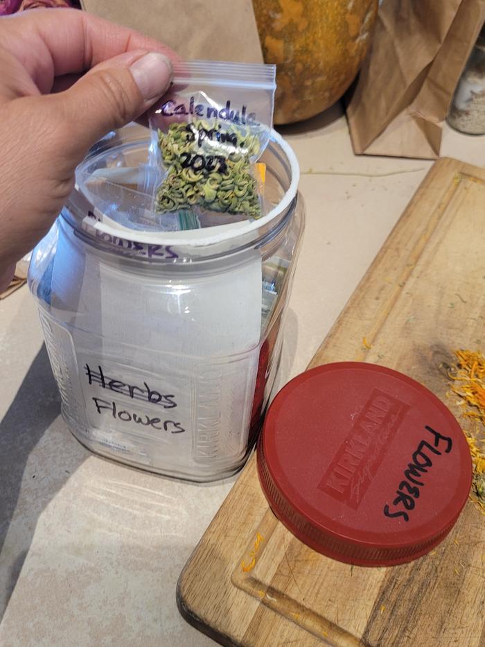 Bag is stored in an airtight container with other root flower seeds.