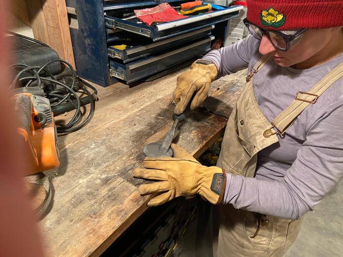 alexandra sharpening the chisel with a 2 grit whetstone