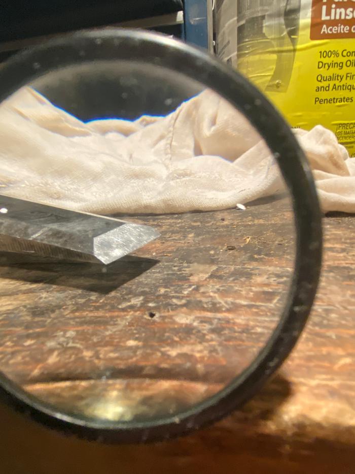 a sharp chisel through a magnifying glass