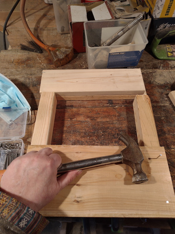 Nailed the boards to the 2x2 frame posts.