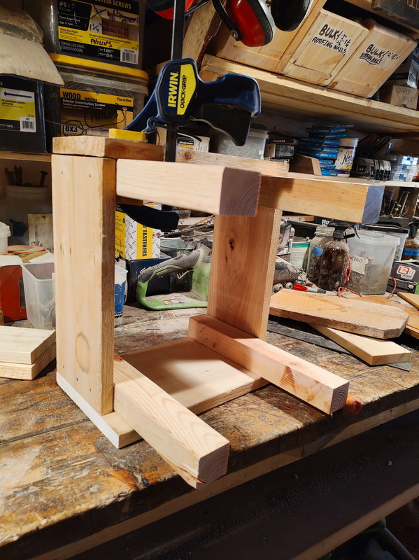 A clamp was quite handy in stabilizing the sides while I nailed them to the posts.