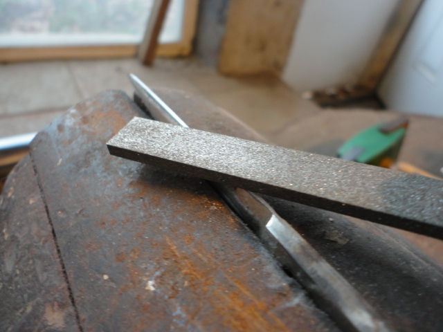 close up action shot of the diamond file working on one side clamped in my vise.