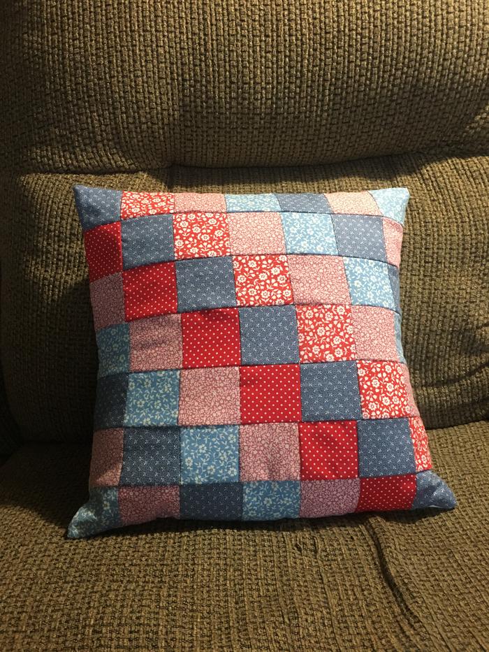 The finished pillow case on a pillow.