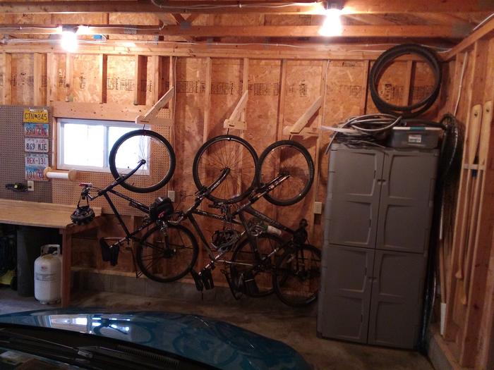 Old garage right side with pivoting bike hangers and canoe paddle storage