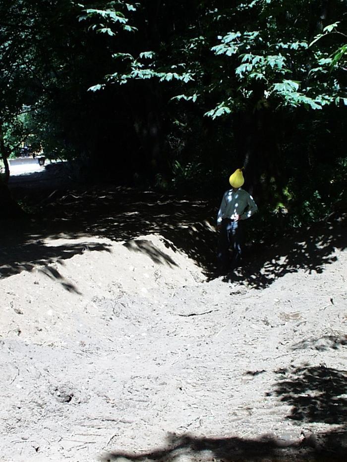 Built up road bed showing bulldozer and depth ditch along the side of the road.