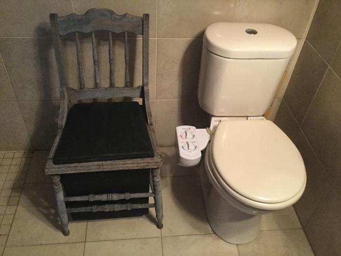 DIY humanure toilet made from chair with broken wicker seat, 5 gallon bucket, plywood seat 