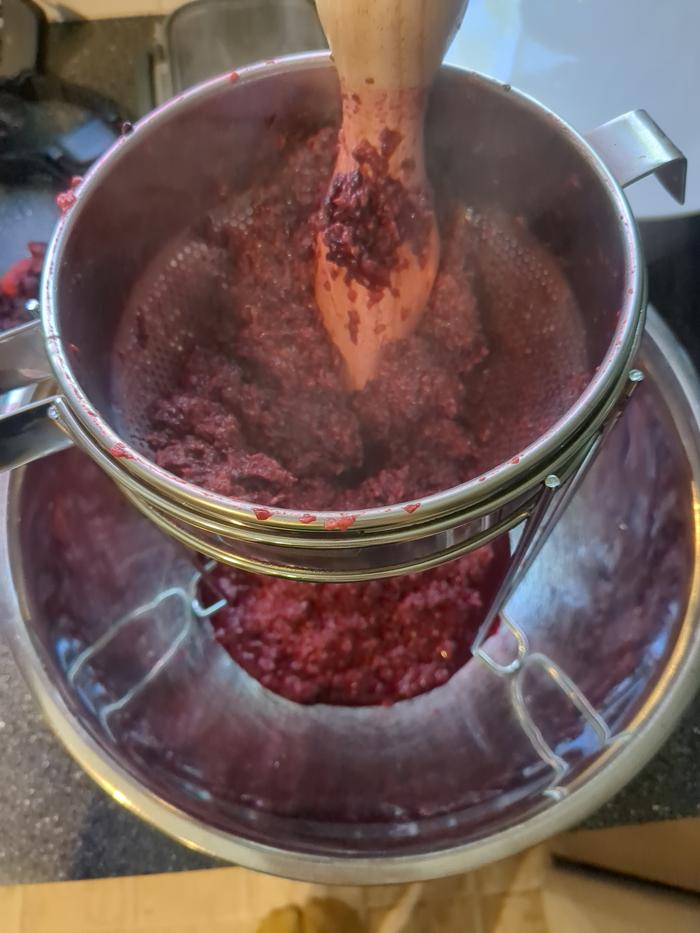 Straining the seeds out of the pulp for jam.