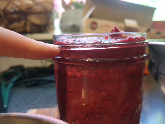 Filled up to the highest bump on the jar.