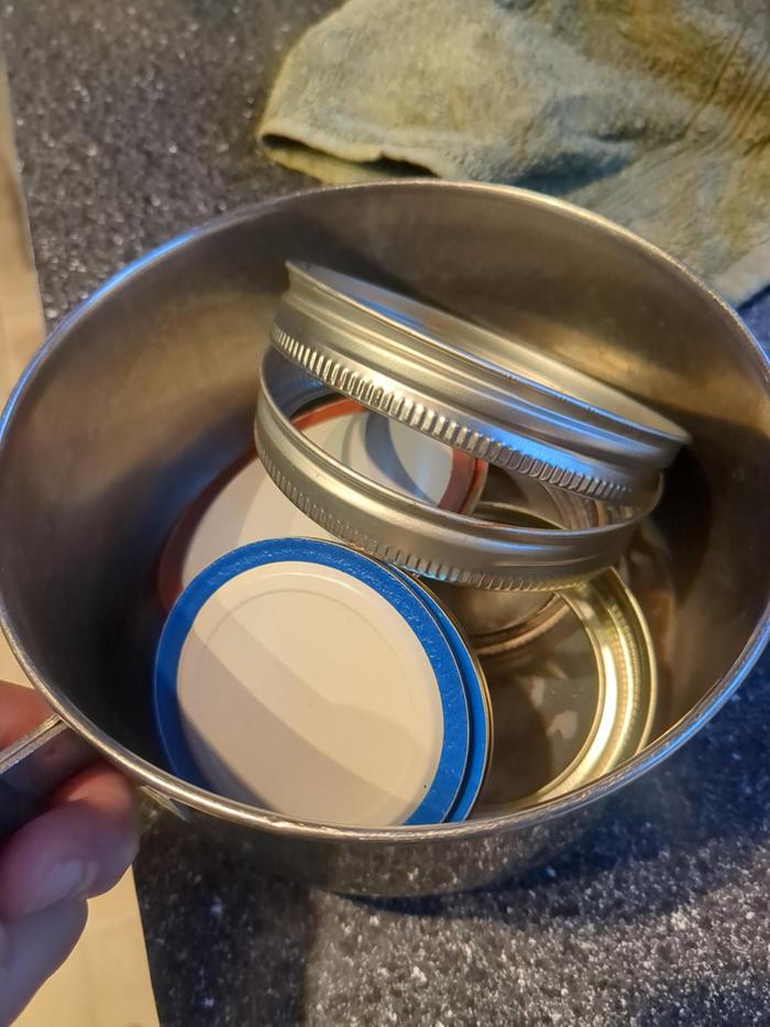 Put the lids in a pot, cover with water, and simmer on the stove to sterilize.