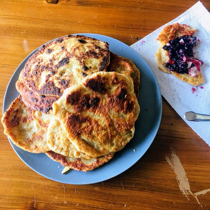 Home-made butter and blueberry preserves on a johnycake.