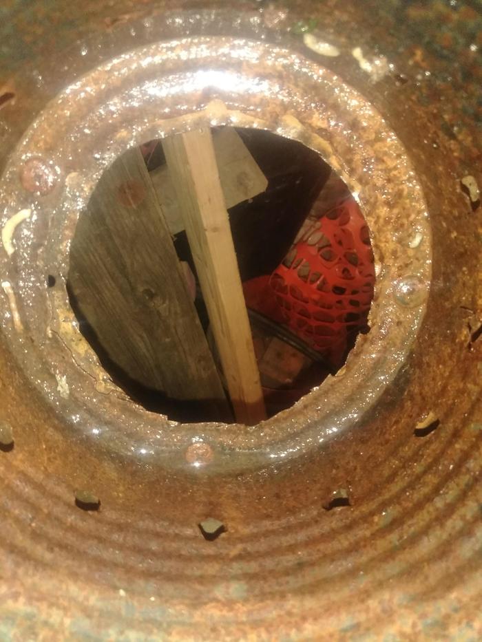 The inside of that same chimney.The hole is smaller in diameter than the can and self tapping screws hold the can to the lid. 