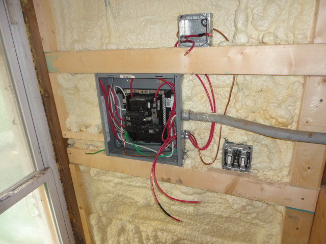 A work in progress shot. I've removed the wall board, added the outlet box, and started running the wires. In this photo I'm trying to use a solid copper ground wire, but it was too stiff so that got replaced.