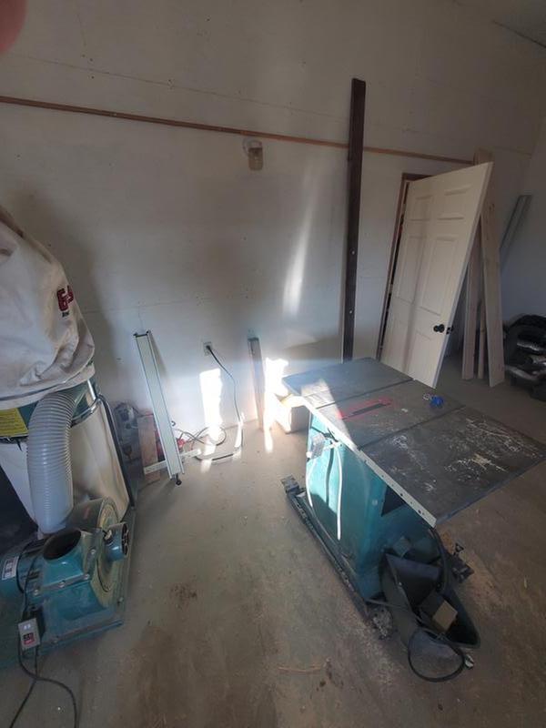 The wall of the shop behind the collector and tablesaw - no 220v!