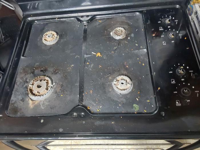 The malfunctioning stovetop minus the grates and burner caps. 