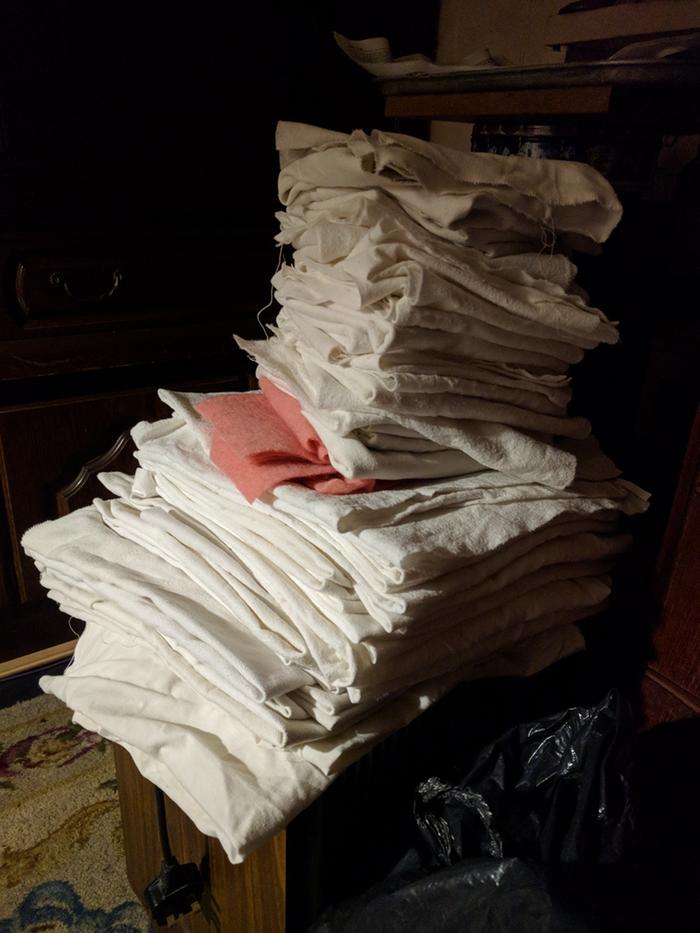 Stack of cut up nappies, cloths and soaker pads (before hemming)