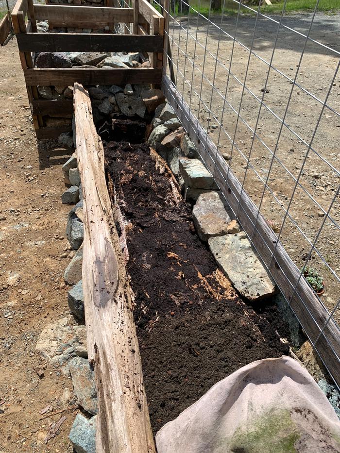 Layer of coffee grounds to help wood decompose
