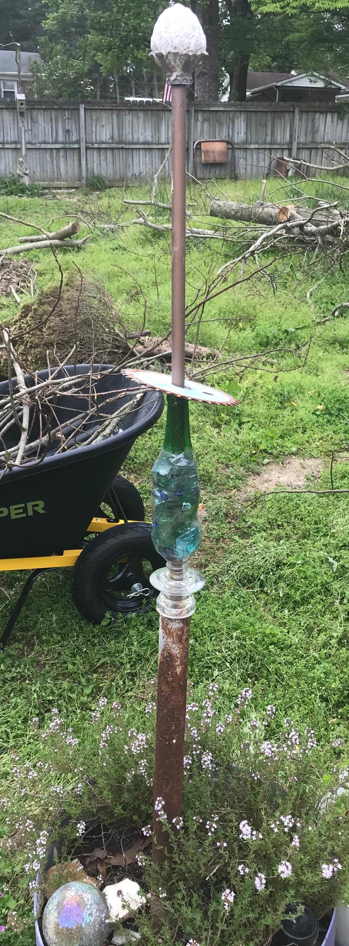 I corralled some colorful broken glass inside a water bottle that I shrunk with a heat gun. 