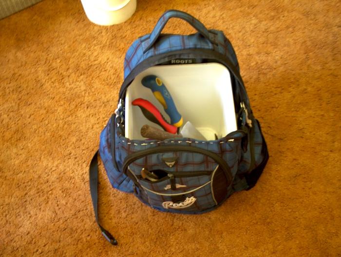The bucket can contain "wet and mud" and keeps sharp tools from damaging the material. I need to put some sort of rubbery/waterproof base on the pack.
