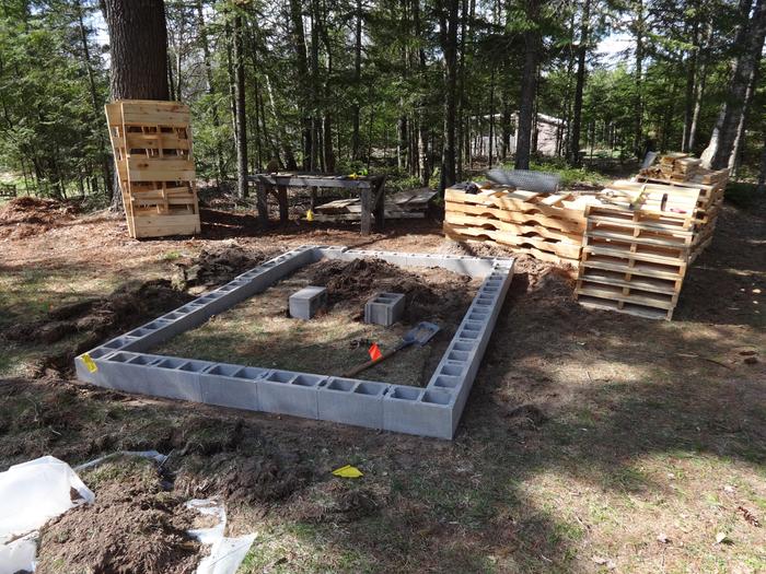 Blocks going down (no mortar). Two in the center to support where the pallets meet.